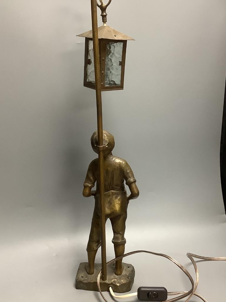 An early 20th century bronzed spelter whistling boy table lamp, 65cm.